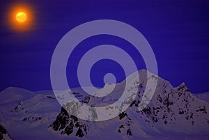 Moon on the dark blue sky of Antarctica