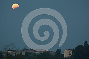 Moon eclipse over the town
