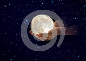 Moon  in hands on front blue cloudy sky hold peace concept natire background