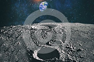 Moon limb with Earth rising on the horizon.Earth rises above lunar horizon. Elements of this image furnished by NASA
