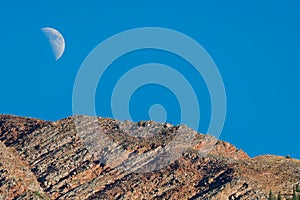 Moon and mountain summit peak