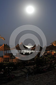 Moon over beach umbrellas