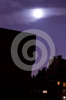 Moon over city skyline