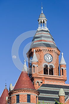 Moon over the clock tower of Old Red Museum in Dallas, Texas