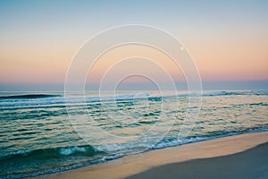 Moon over the Gulf of Mexico at sunrise, in Panama City Beach, Florida