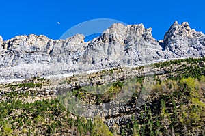 Moon over the mountain in Ordesa Valley, Aragon, Spain