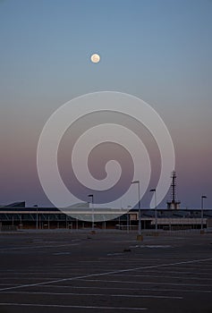 Moon over sunset from a car park