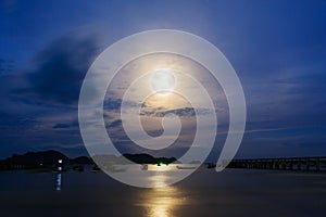 Moon rises over the fishing pier.