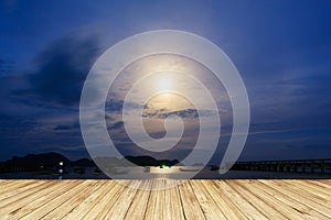 Moon rises over the fishing pier.