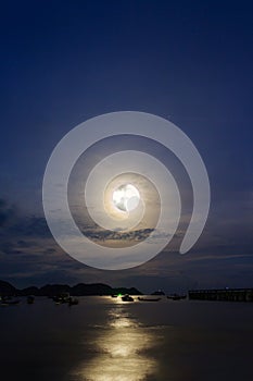 Moon rises over the fishing pier.