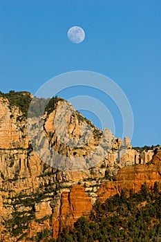 Moon rises over mesas and buttes near Sedona, Arizona photo