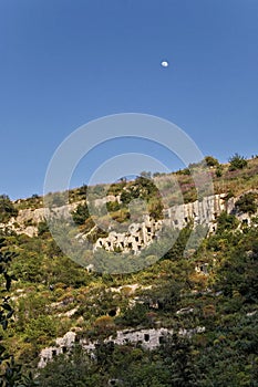 The Moon rises over the rocky necropolis of Pantalica in Sicily