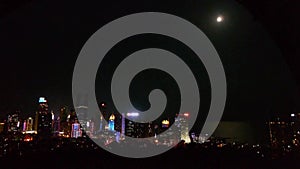 Moon rising over urban skyline,china QingDao(tsingtao).