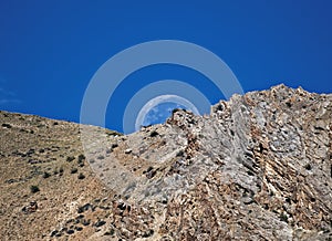 The moon setting behind the mountain looks amazing