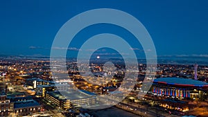 Moon setting over mountain as dawn