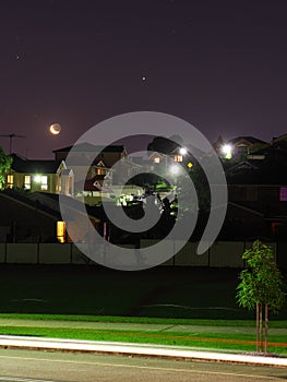 Moon and stars night scene residential area