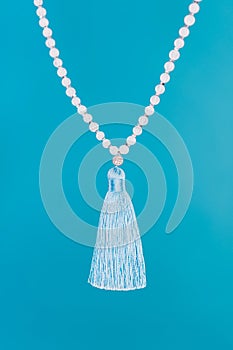 Moon stone mala beads on blue background. Gemstone strand used for keeping count during mantra meditations. Spirituality