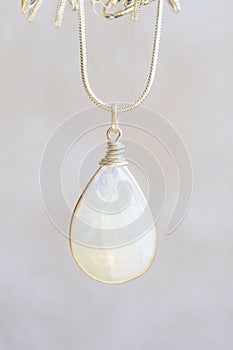 Moon stone sterling silver simple pendant on neutral background