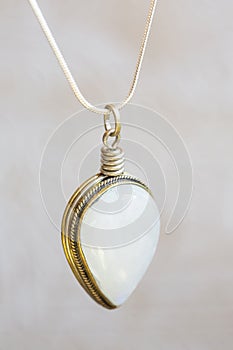 Moon stone sterling silver simple pendant on neutral background