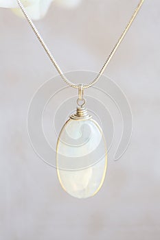 Moon stone sterling silver simple pendant on neutral background