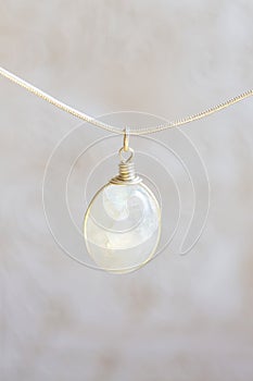 Moon stone sterling silver simple pendant on neutral background