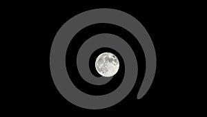 Moon time lapse, stock time lapse: full moon rise in dark nature sky, night time. Full moon disk time lapse with moon light up in