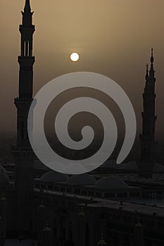 Moon between two towers of the Prophet's Mosque in Al Madinah, Saudi Arabia photo
