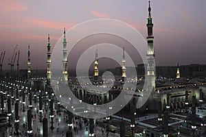 Moon between two towers of the Prophet\'s Mosque in Al Madinah, Saudi Arabia photo