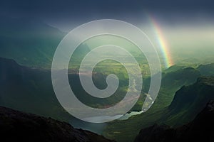 moonbow above a foggy valley, creating a mystical atmosphere