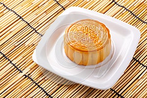 Mooncake and tea on bamboo background