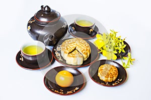 Mooncake and tea, food and drink for Chinese mid autumn festival. Isolated on white background.