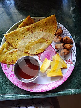 Moong daal chilka with pakodey and mangoes