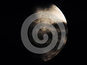 Moonlight breaking through clouds on dark night