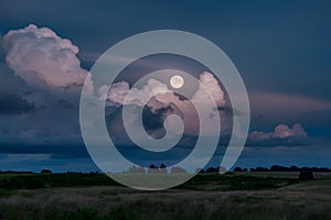 Moonlight filters through billowing clouds in a mesmerizing scene