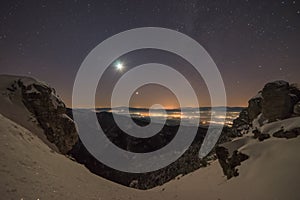 Moon and night sky over the winter land