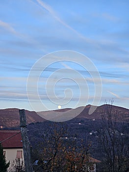 Moonlight and sunset over the mountain