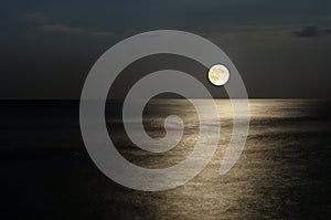 Moonlight on the waves at night in the sea on long exposures