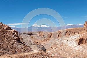 Moonlike landscape of dunes, rugged mountains and rock formations of Valle de la Luna Moon valley, Atacama desert, Chile