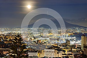 Moonlit cityscape of Naples with Mount Vesuvius