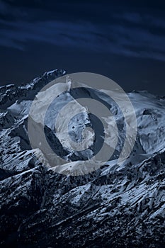 Moonlit high mountain landscape at night photo