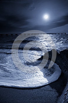 Moonlit Pier with Circular Ocean Wave