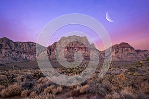 Moonrise at dawn over a Mountain Range in Red Rock Canyon Nevada