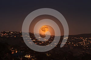 Moonrise of a full moon over the coastline of Laguna Beach