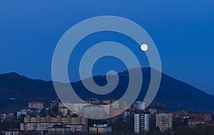 Moonrise. Moonrise over the Jaizkibel mountain and the city of Donostia San Sebastian, Basque Country photo