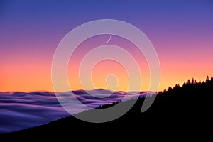 Moonrise over inversion clouds photo