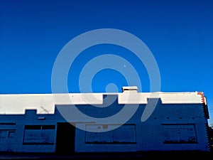 Moonrise Over a Shadowed Building