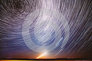 Moonrise Sky Natural Background. Unusual Amazing Stars Effect In Sky. Trace Of Moon. Spin Of Star And Meteoric Trails On