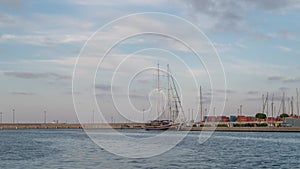 Moonrise on Valencia port Through a wooden boat, time-lapse