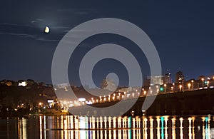Moonset in Kiev over Dnieper river in lights photo