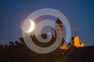 Moonset over old church